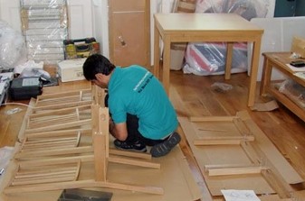 Worker assembling a set of chairs